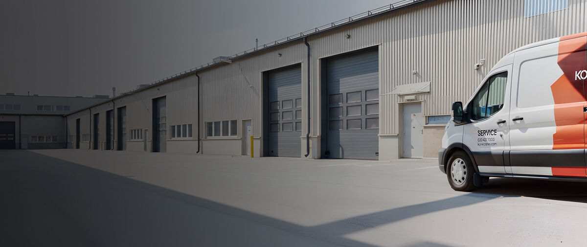 Man and a service van outside an industrial building