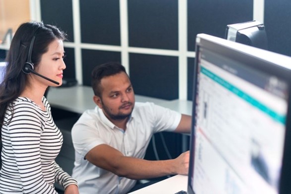 Remote Agilon global technical remote service. Man and woman inspecting screen